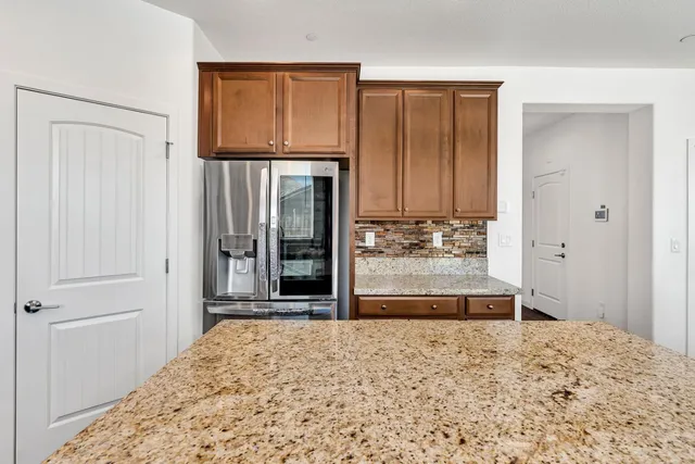 a view of a hallway with wooden floor and entryway