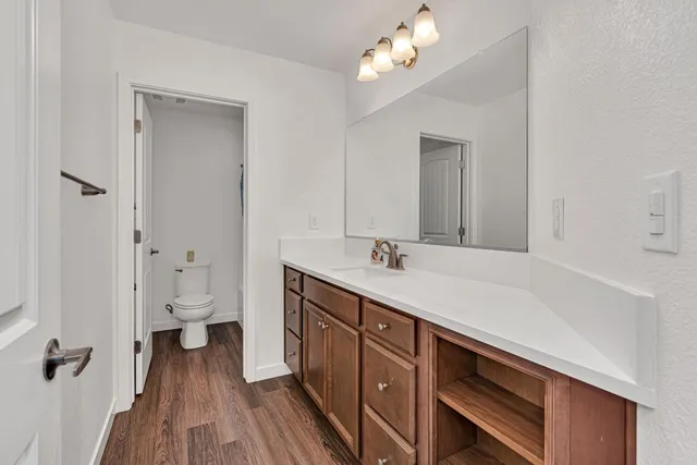 a spacious bedroom with a bed and a chandelier