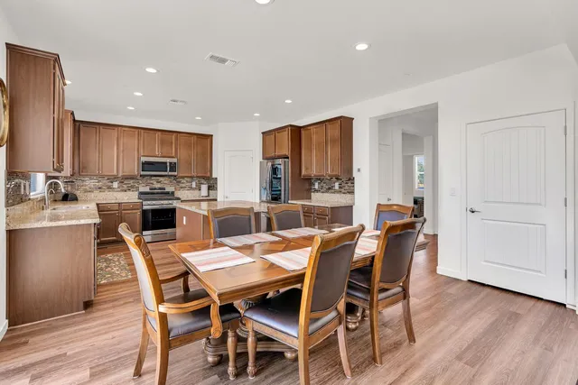 a view of a dining room with furniture and wooden floor