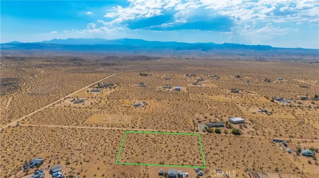a view of an ocean beach and mountain