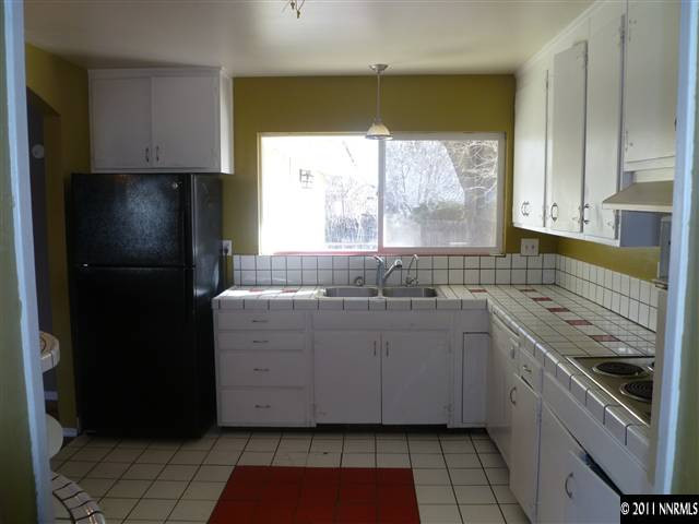 1290 Earl Drive Reno, NV 89503 - Photo 2 of 13 a kitchen with granite countertop a refrigerator and a sink