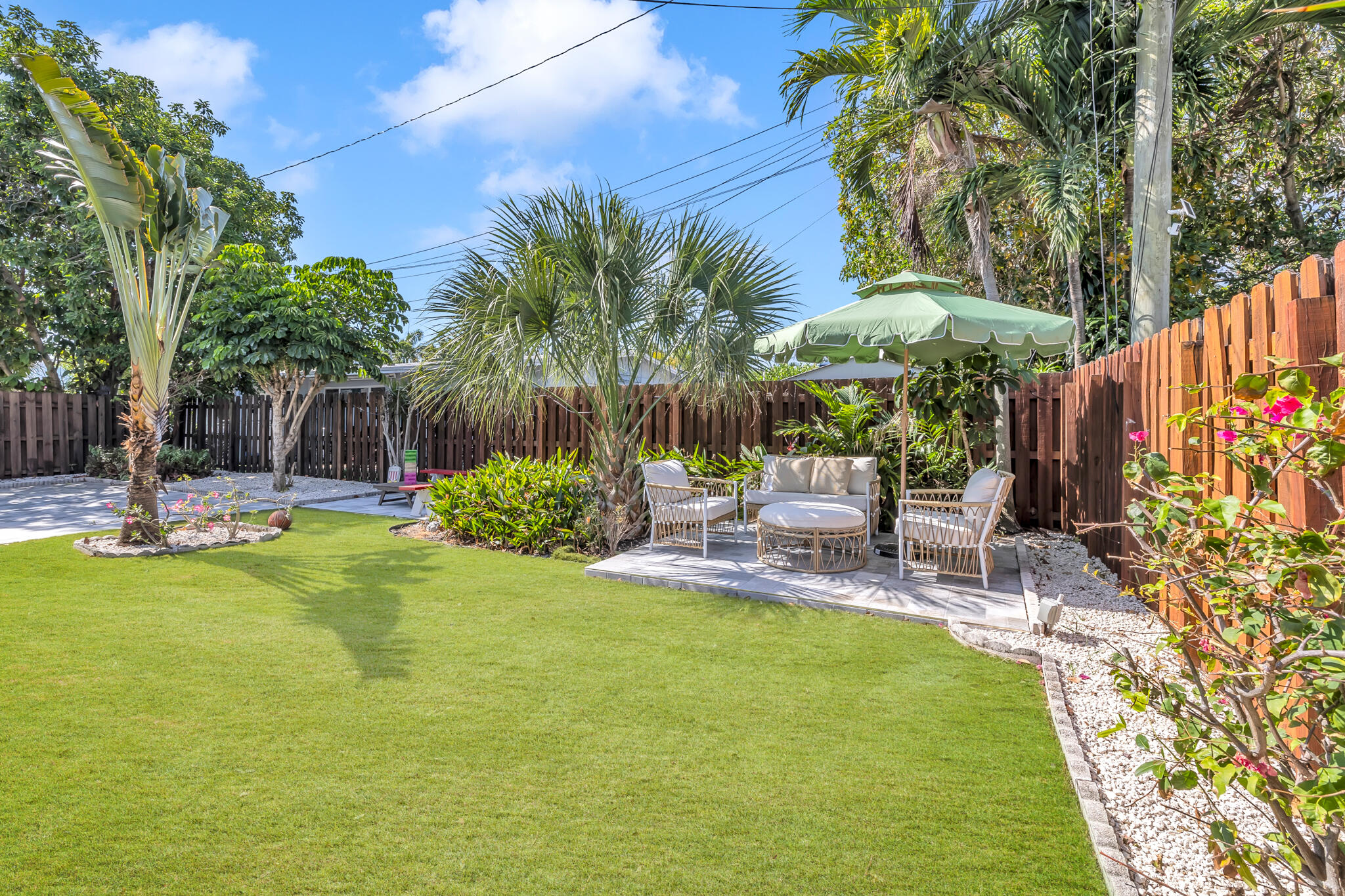 2412 Northeast 4th Street, Unit W Pompano Beach, FL 33062 - Photo 13 of 18 a view of a swimming pool with sitting area and garden