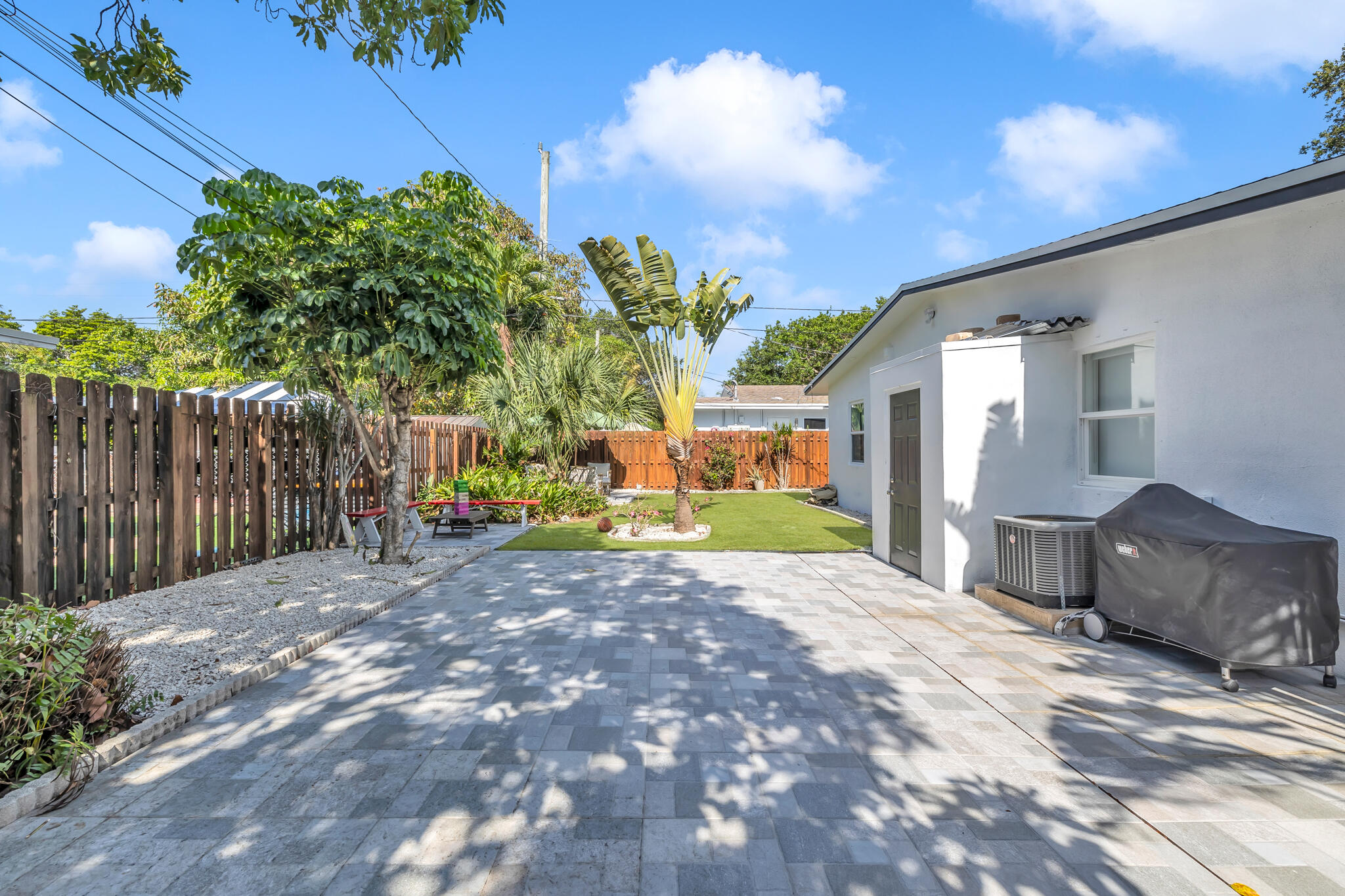 2412 Northeast 4th Street, Unit W Pompano Beach, FL 33062 - Photo 15 of 18 a view of a house with backyard and a tree