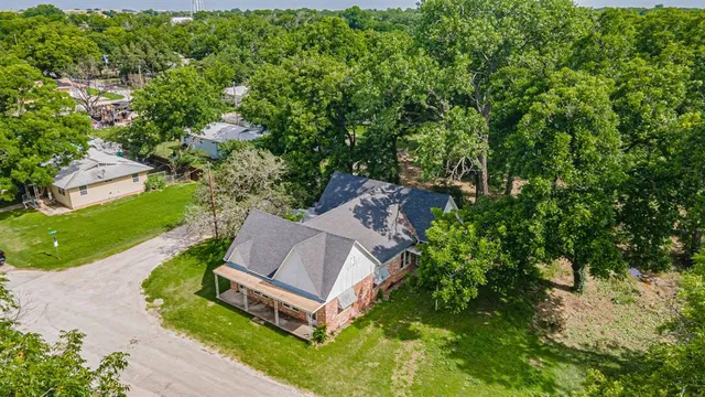 an aerial view of a house with a yard