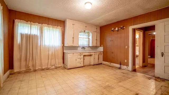 a view of a kitchen with stainless steel appliances granite countertop furniture and a window