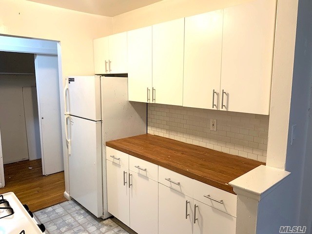 a kitchen with a refrigerator and a sink