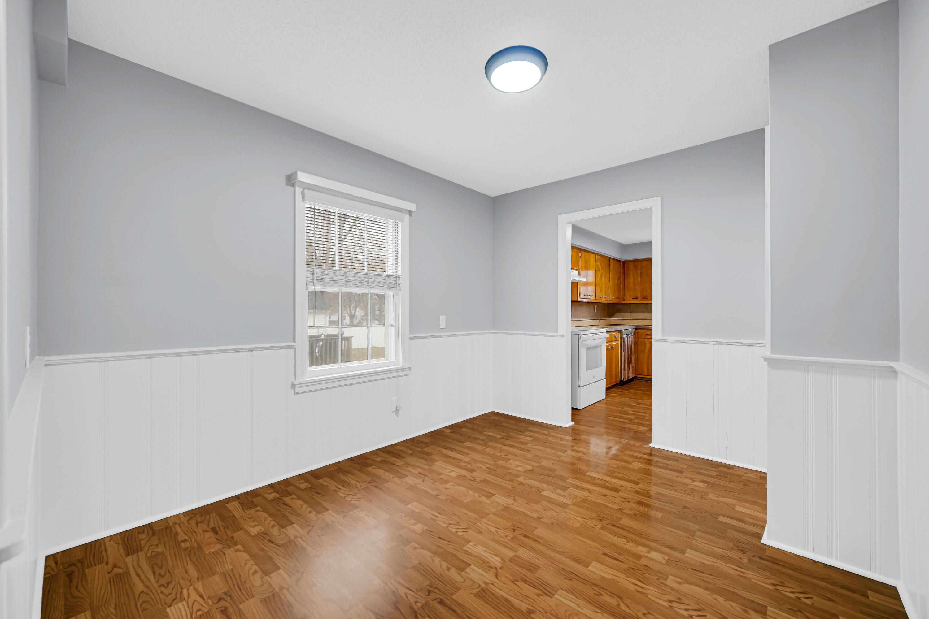 600 West North Street Crown Point, IN 46307 - Photo 6 of 24 an empty room with wooden floor and windows