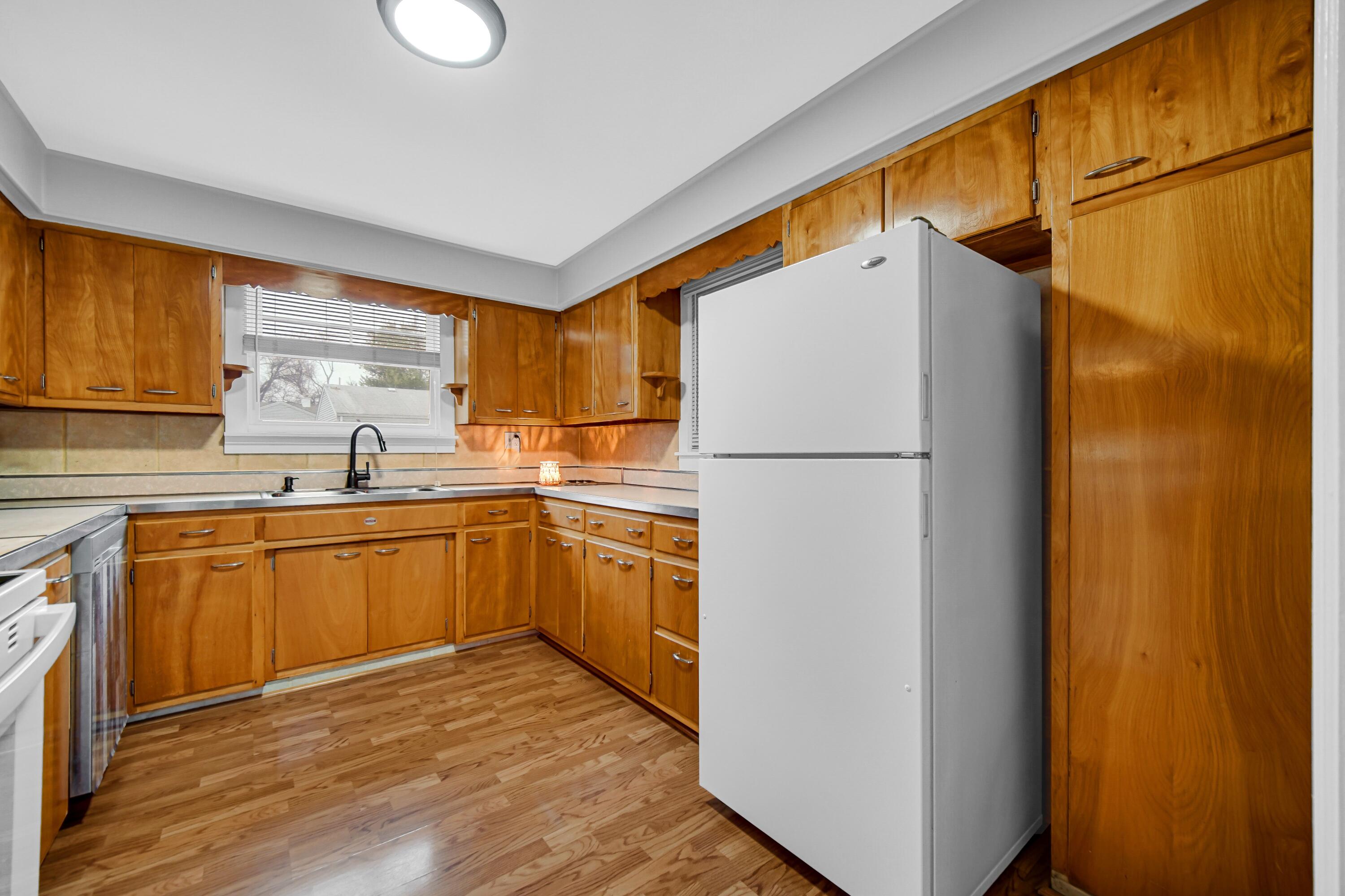 600 West North Street Crown Point, IN 46307 - Photo 9 of 24 a kitchen with a refrigerator sink and cabinets