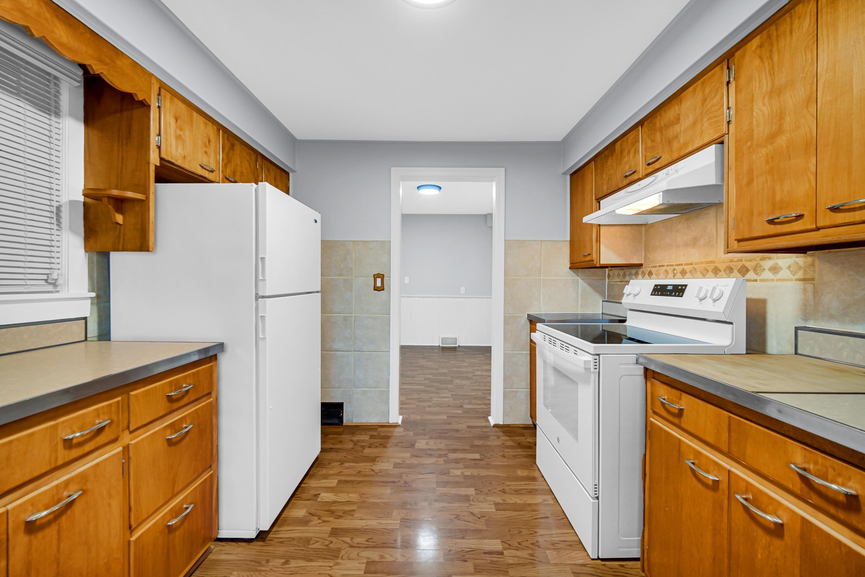 600 West North Street Crown Point, IN 46307 - Photo 10 of 24 a kitchen with a refrigerator a stove top oven a sink and cabinets