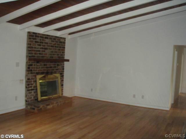 1851 Rabbit Warren Road Manakin-Sabot, VA 23103 - Photo 3 of 7 a view of empty room with wooden floor and fireplace