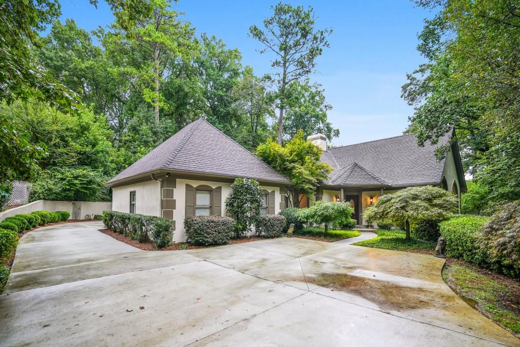 229 North Mill Road Atlanta, GA 30328 - Photo 1 of 1 a front view of a house with a garden