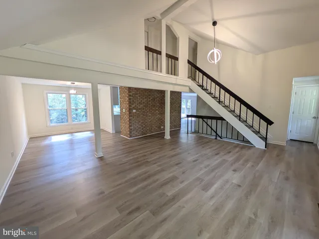 a view of an entryway with wooden floor