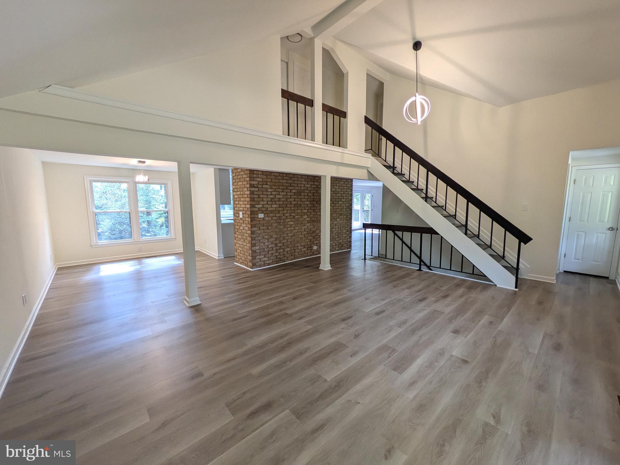 a view of an entryway with wooden floor