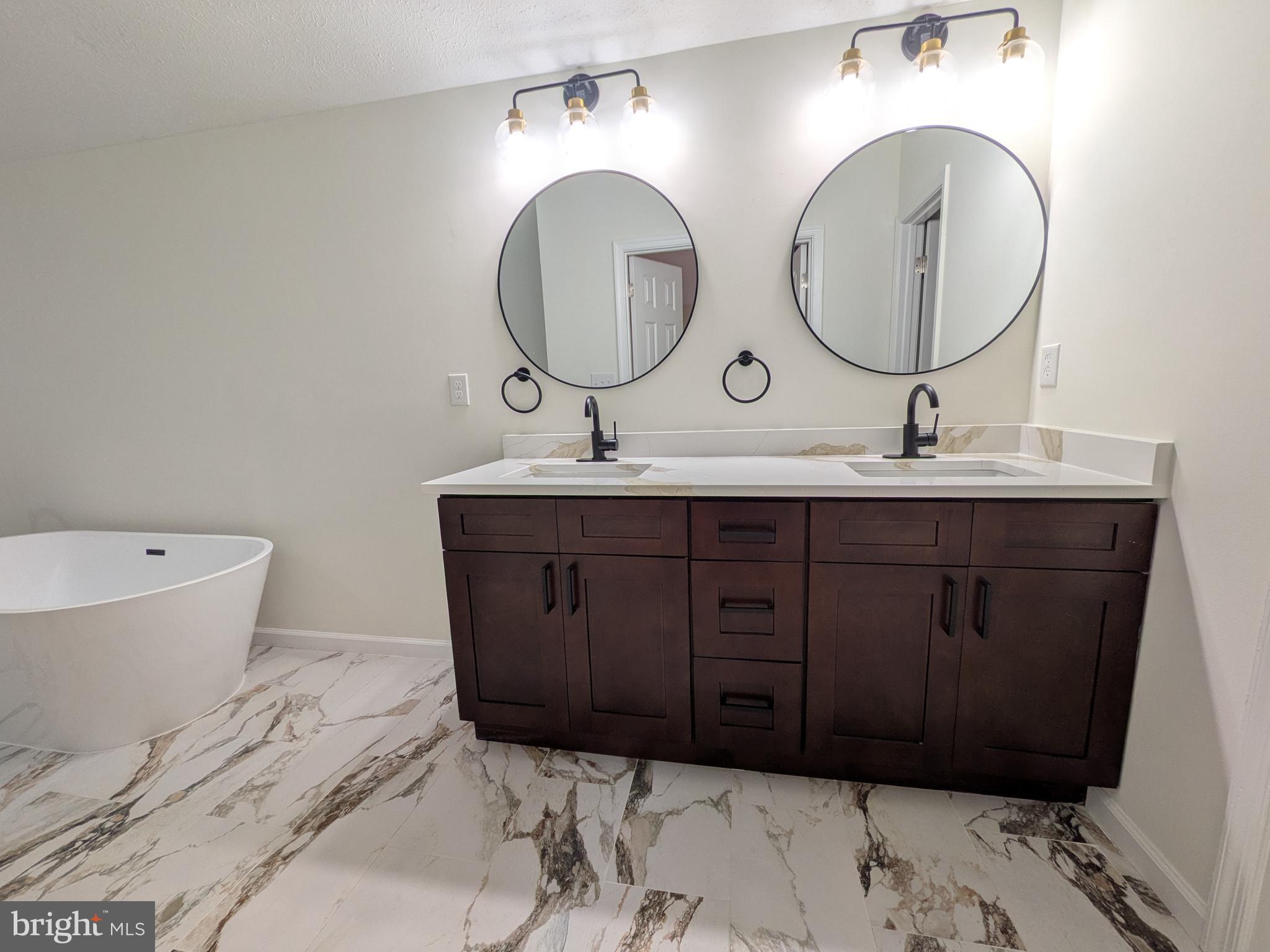 1019 Isabella Drive Stafford, VA 22554 - Photo 12 of 20 a bathroom with a double vanity sink and a mirror