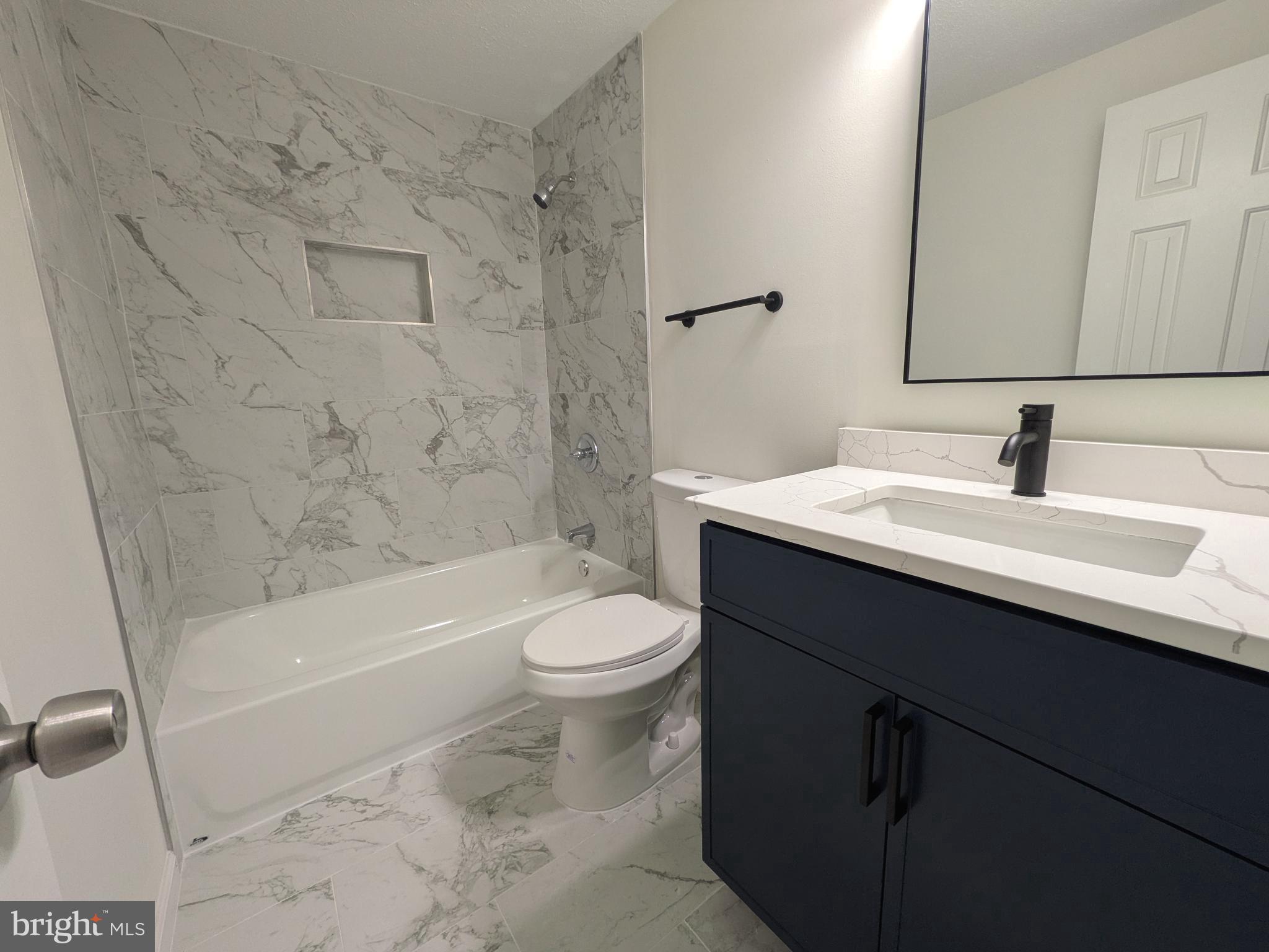 1019 Isabella Drive Stafford, VA 22554 - Photo 16 of 20 a bathroom with a sink a toilet and a bathtub