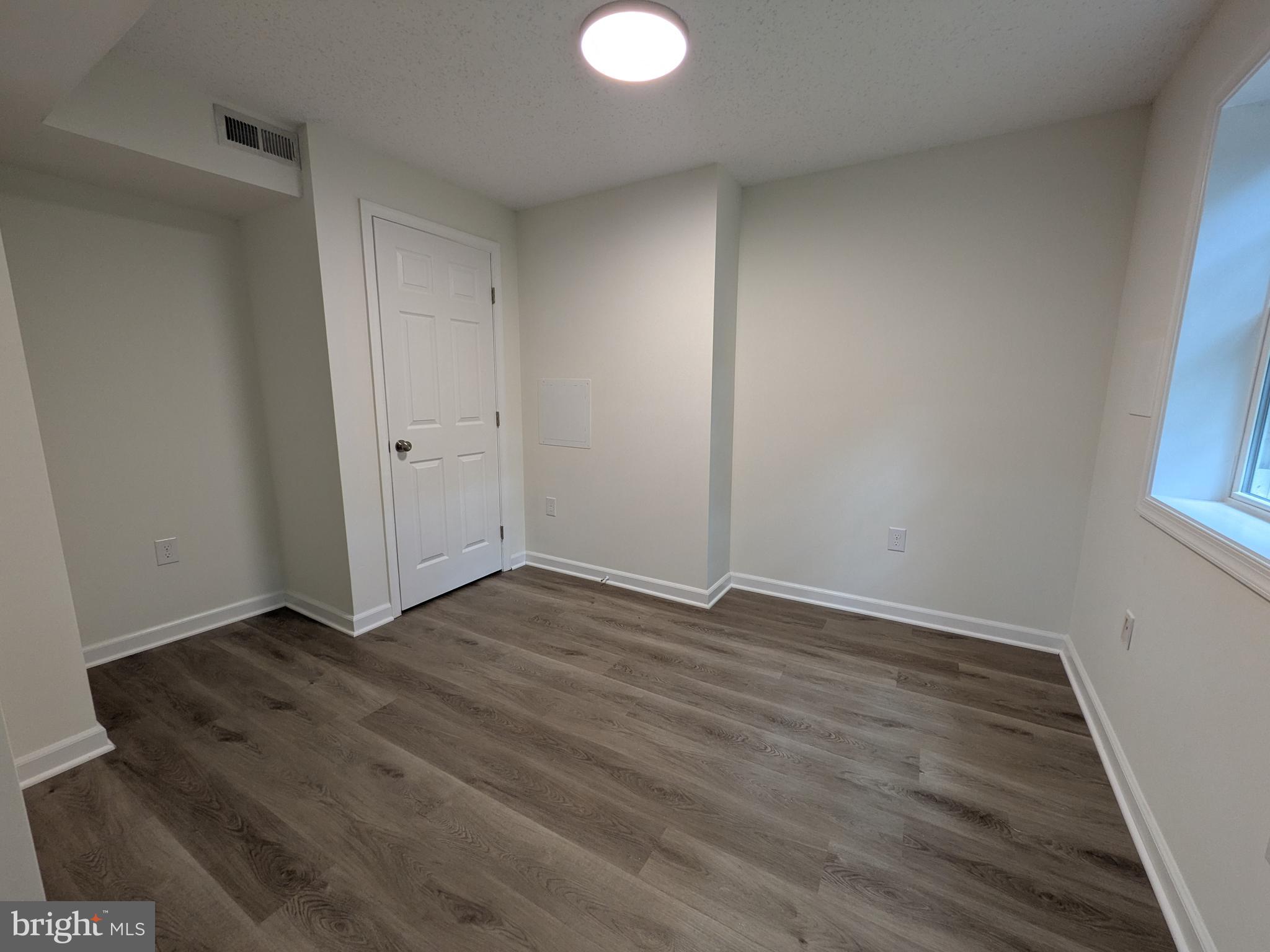 1019 Isabella Drive Stafford, VA 22554 - Photo 17 of 20 a view of an empty room with wooden floor and a window