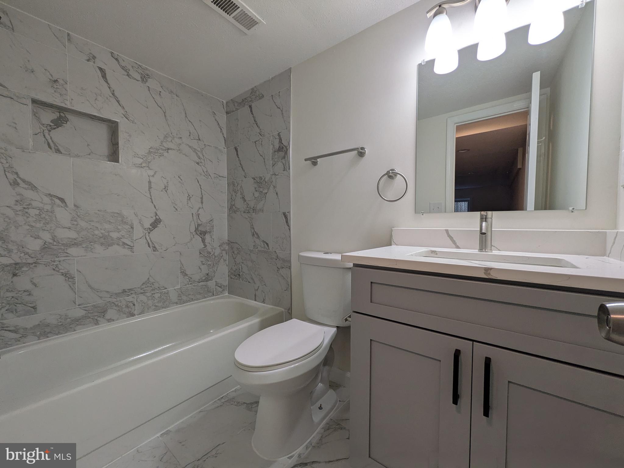 1019 Isabella Drive Stafford, VA 22554 - Photo 20 of 20 a bathroom with a sink a toilet and a mirror