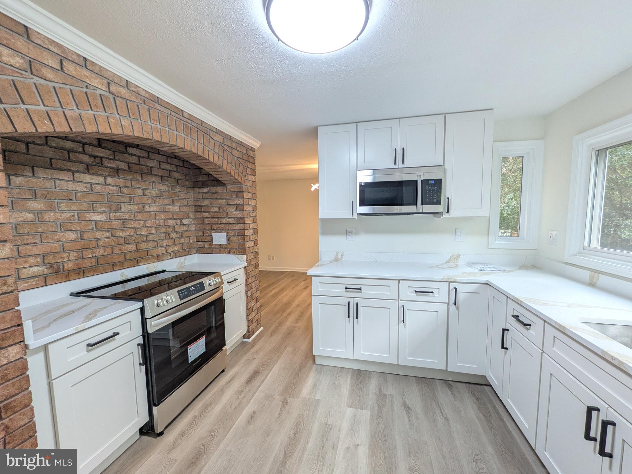 1019 Isabella Drive Stafford, VA 22554 - Photo 2 of 20 a kitchen with granite countertop a stove top oven sink and cabinets