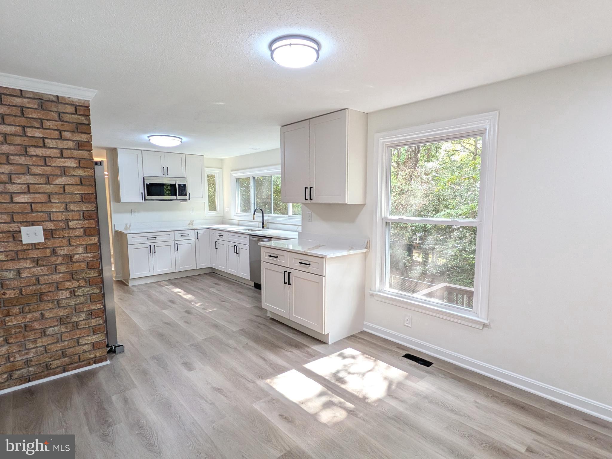 1019 Isabella Drive Stafford, VA 22554 - Photo 4 of 20 a kitchen with a stove a sink and a microwave