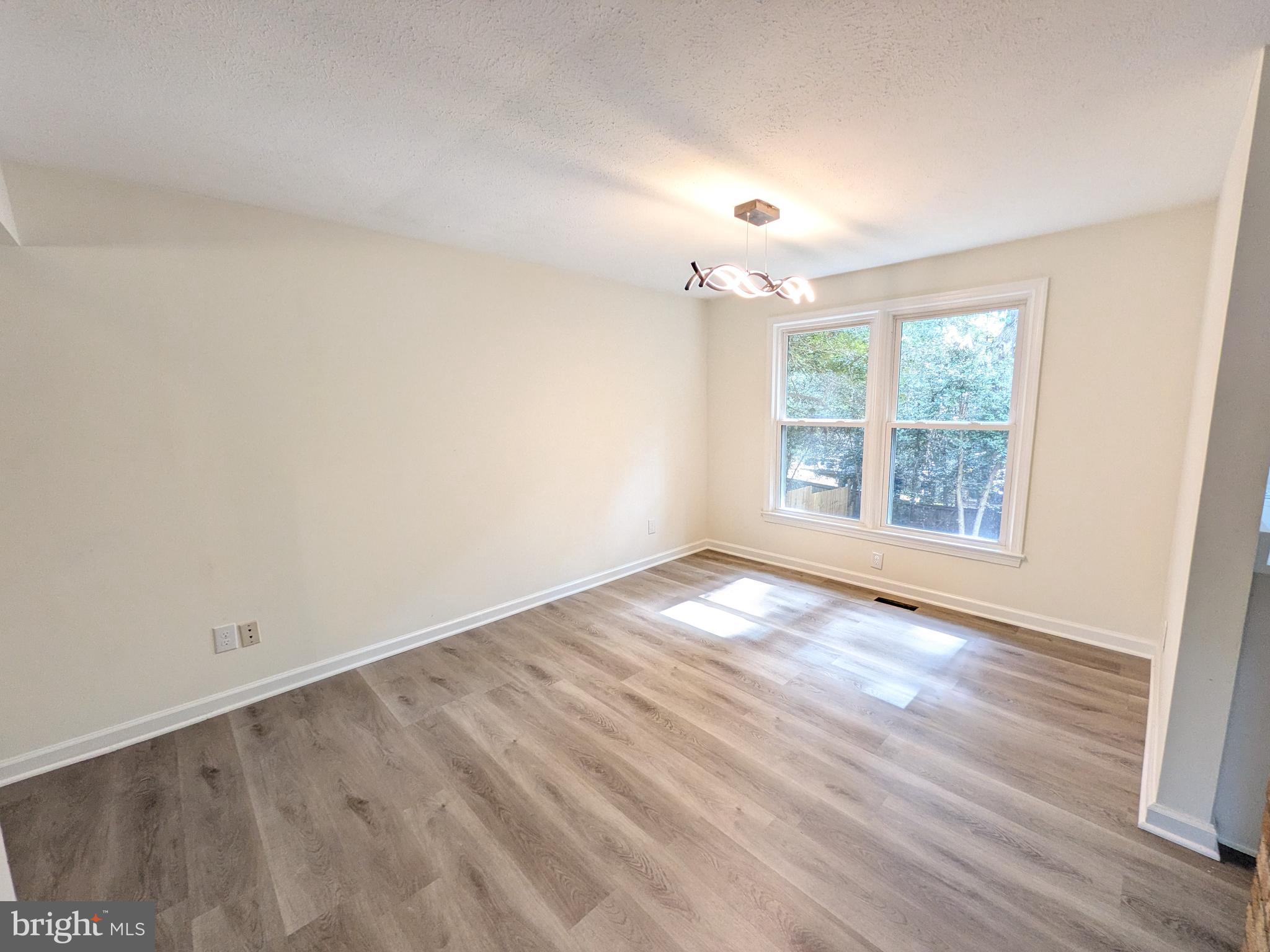 1019 Isabella Drive Stafford, VA 22554 - Photo 6 of 20 an empty room with wooden floor and windows