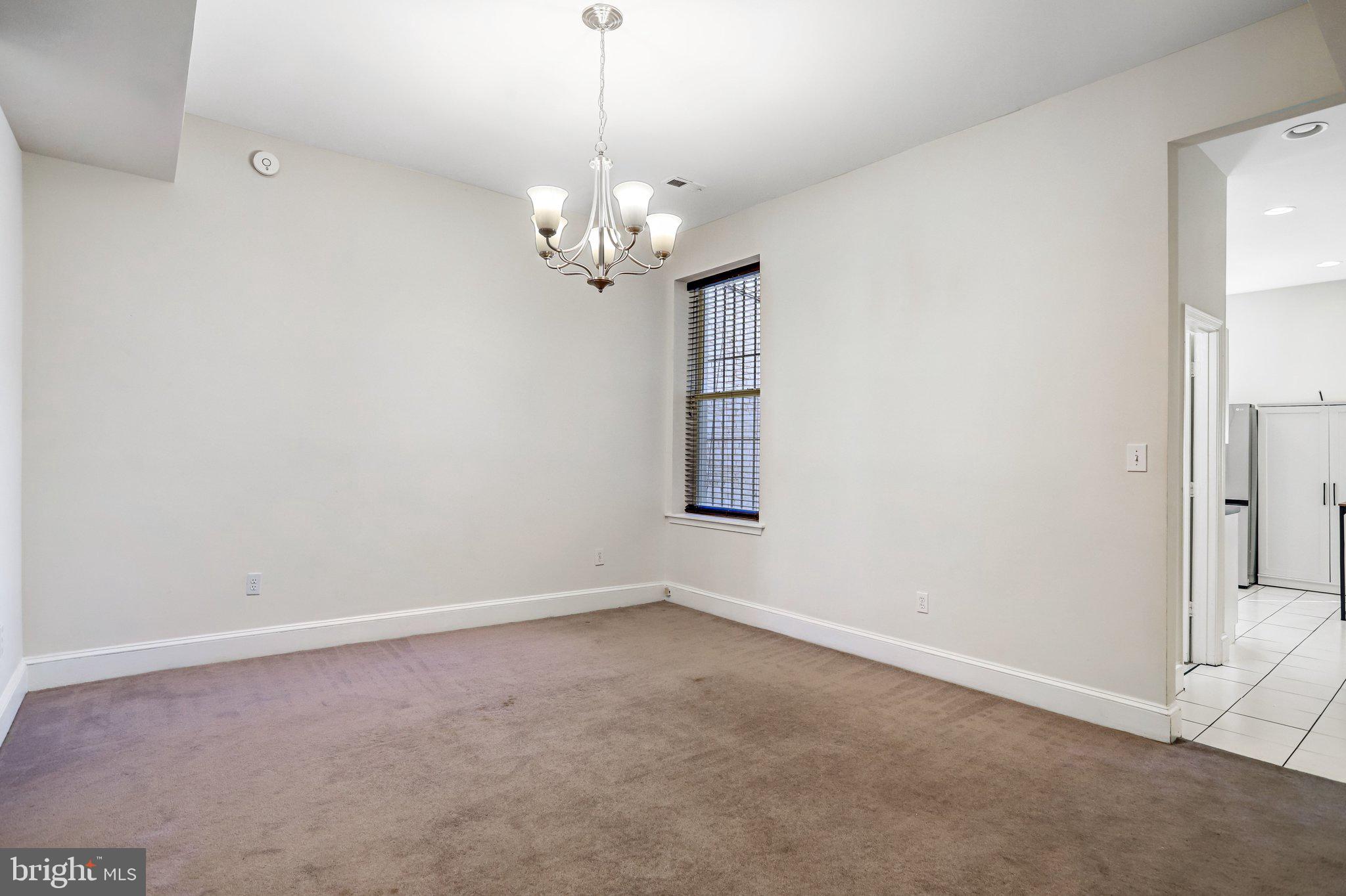 12 Rhode Island Avenue Northwest Washington, DC 20001 - Photo 17 of 74 an empty room with a chandelier fan and windows