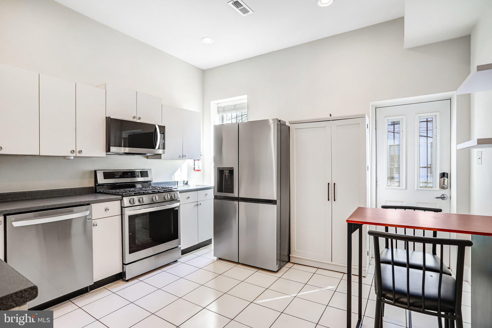 12 Rhode Island Avenue Northwest Washington, DC 20001 - Photo 19 of 74 a kitchen with stainless steel appliances granite countertop a refrigerator stove and microwave