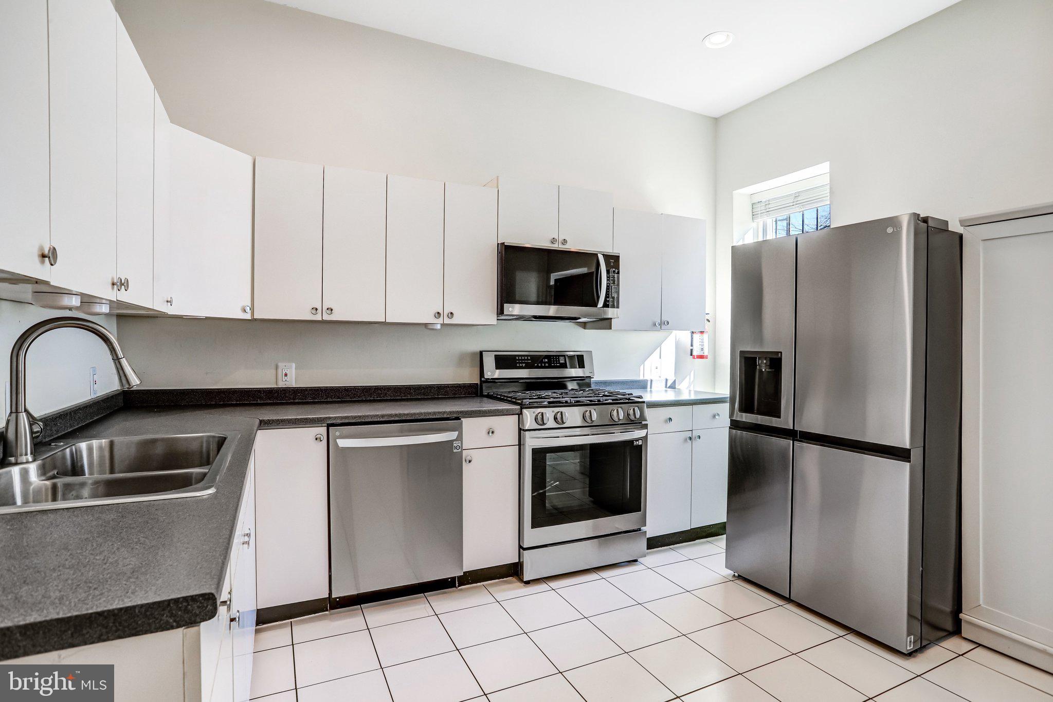 12 Rhode Island Avenue Northwest Washington, DC 20001 - Photo 20 of 74 a kitchen with stainless steel appliances granite countertop a refrigerator sink and stove