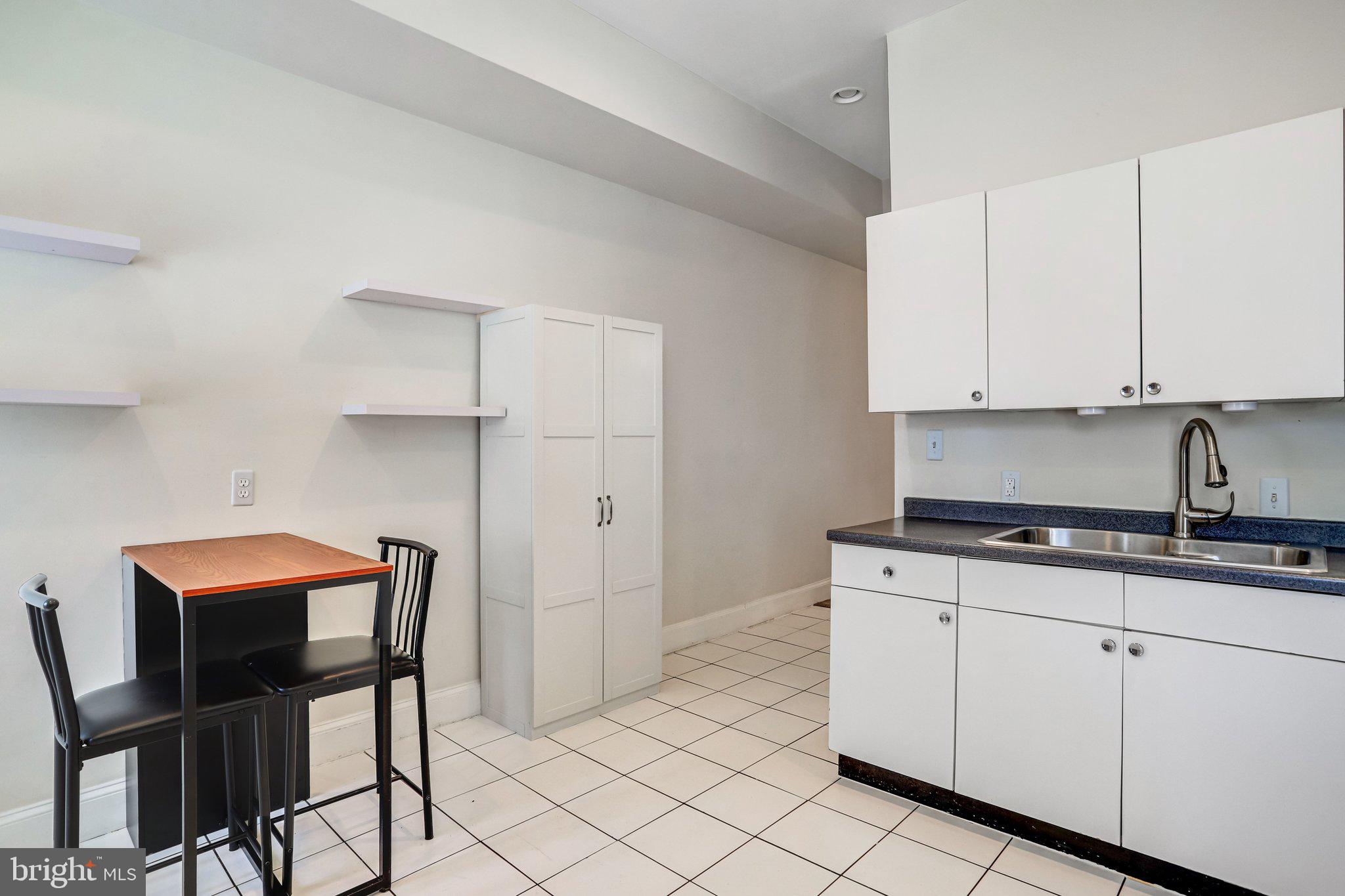 12 Rhode Island Avenue Northwest Washington, DC 20001 - Photo 23 of 74 a kitchen with stainless steel appliances granite countertop a stove a sink and white cabinets