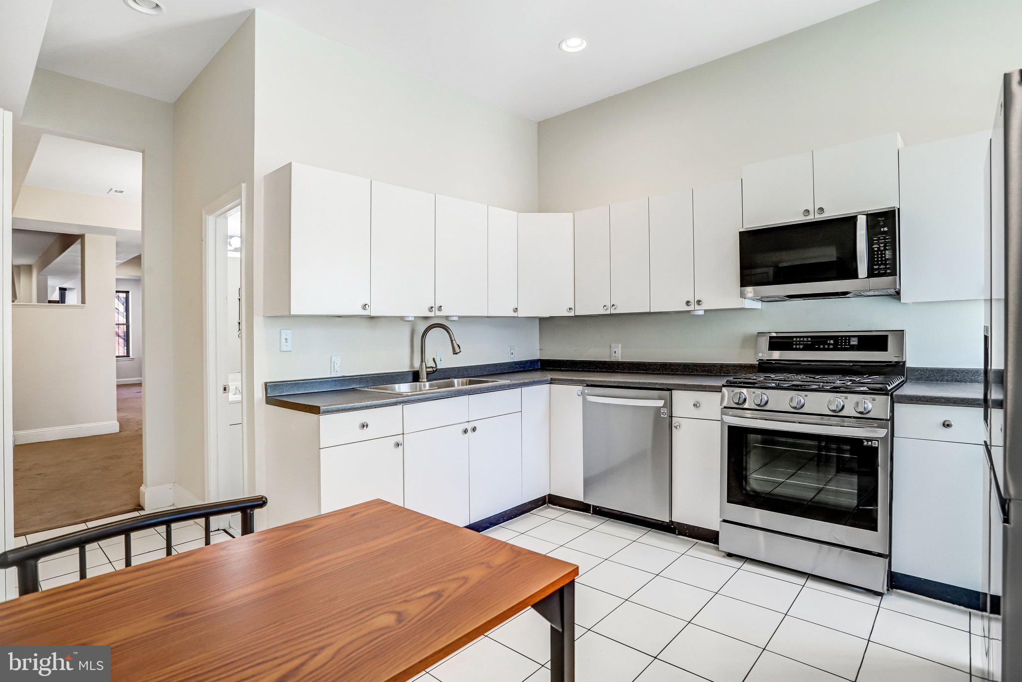 12 Rhode Island Avenue Northwest Washington, DC 20001 - Photo 24 of 74 a kitchen with stainless steel appliances granite countertop a stove a sink and a microwave