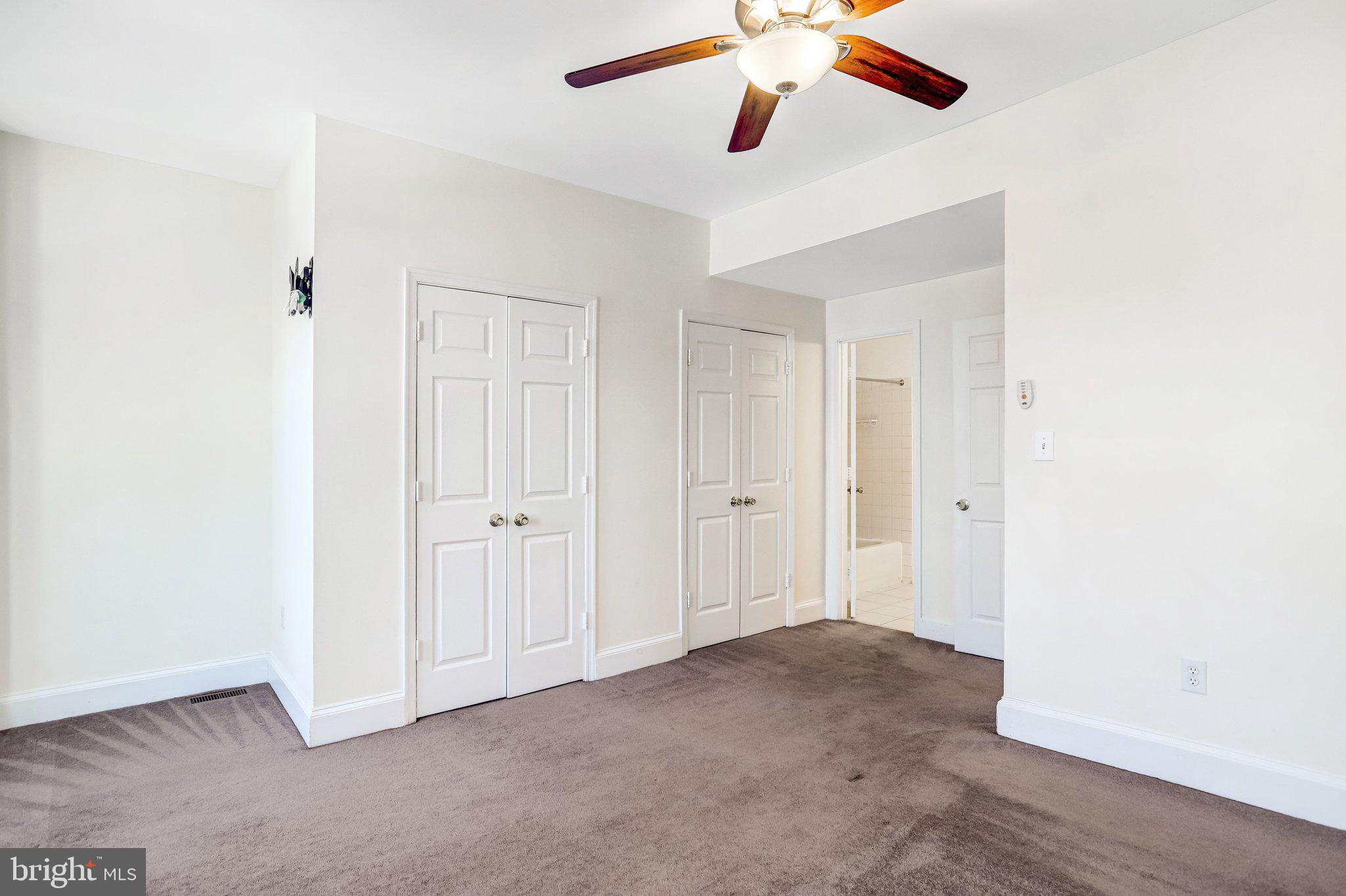 12 Rhode Island Avenue Northwest Washington, DC 20001 - Photo 29 of 74 an empty room with a ceiling fan and wooden floor
