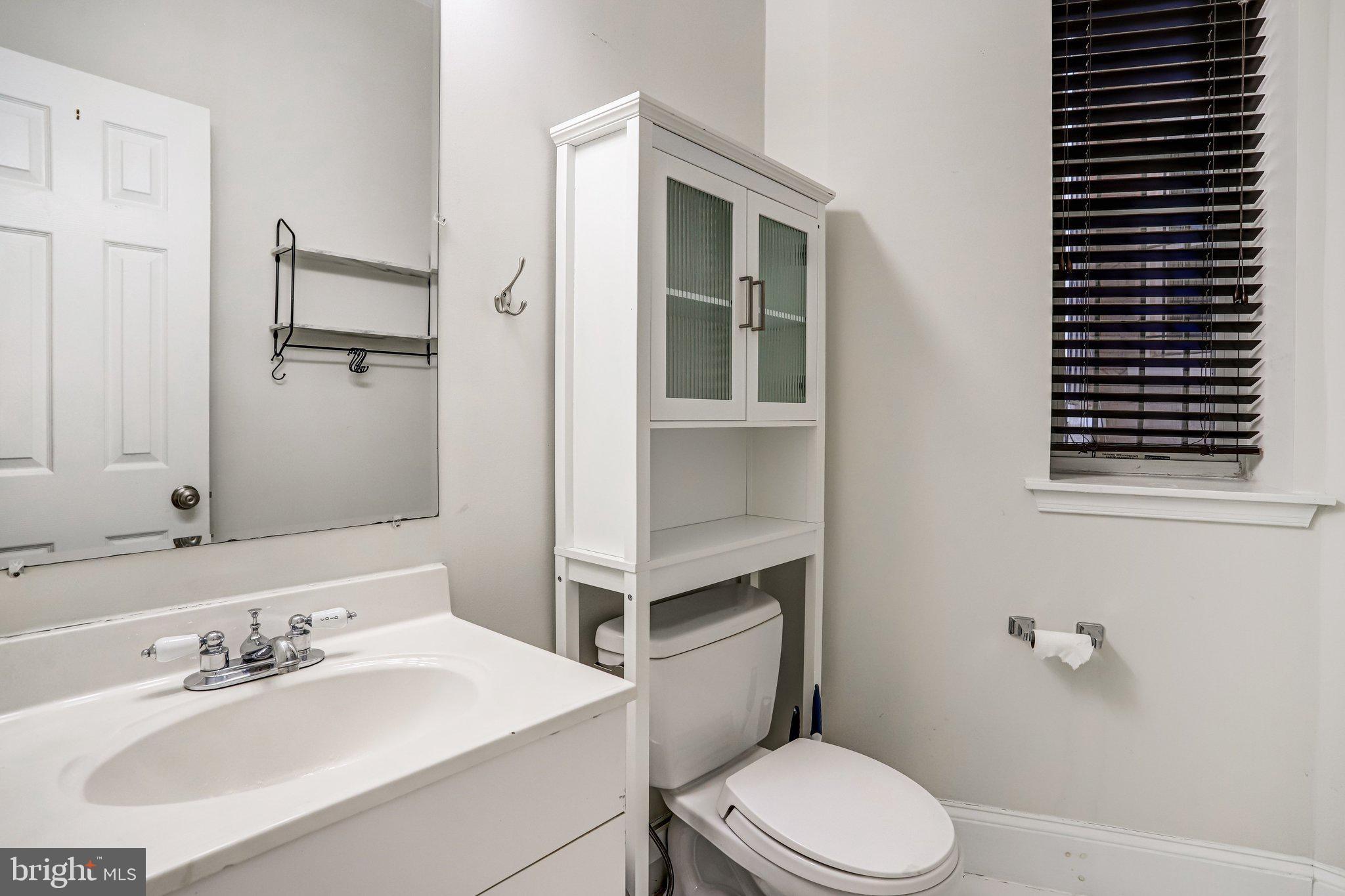 12 Rhode Island Avenue Northwest Washington, DC 20001 - Photo 31 of 74 a bathroom with a sink toilet and mirror