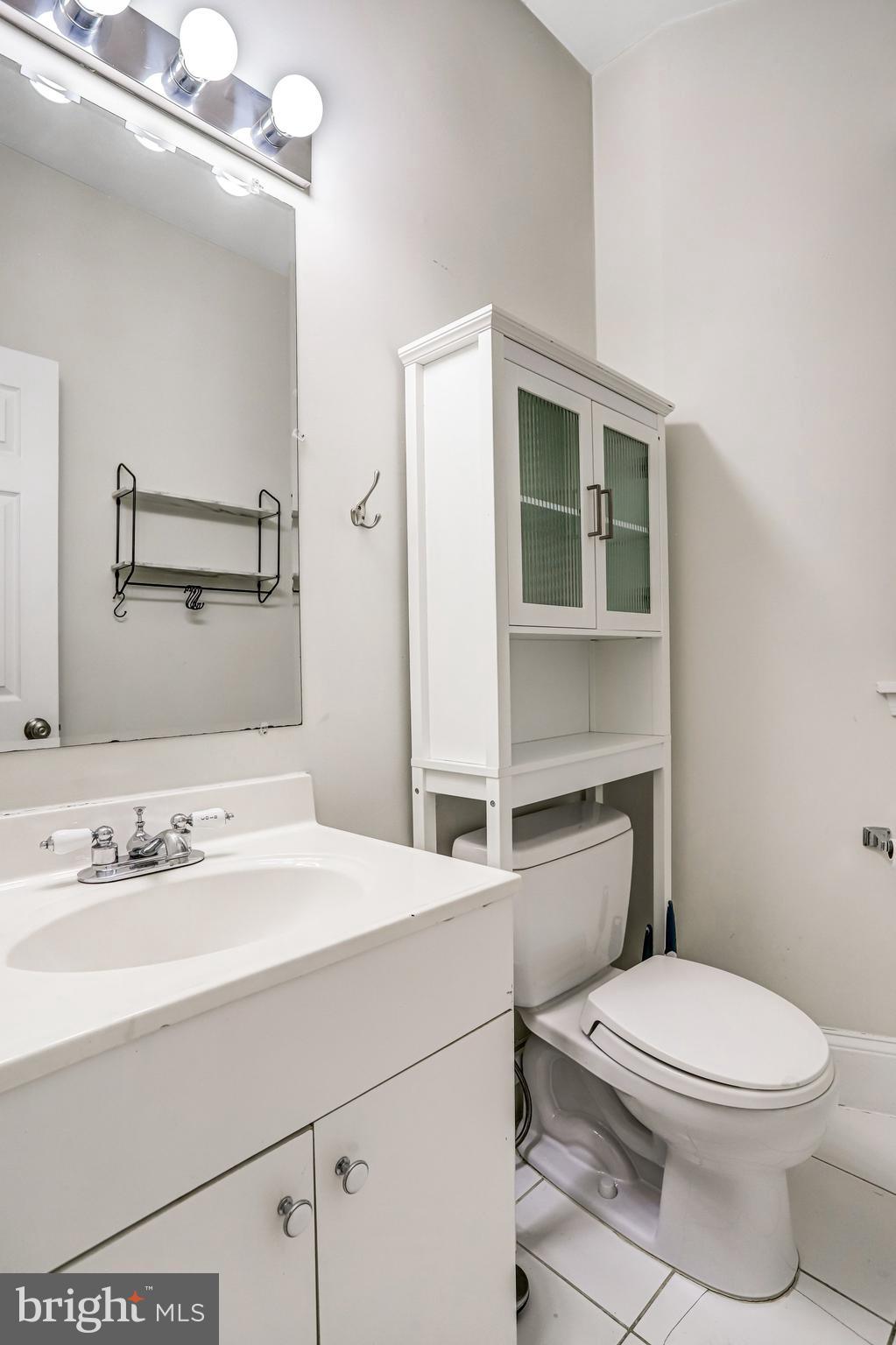 12 Rhode Island Avenue Northwest Washington, DC 20001 - Photo 32 of 74 a bathroom with a sink a toilet and mirror