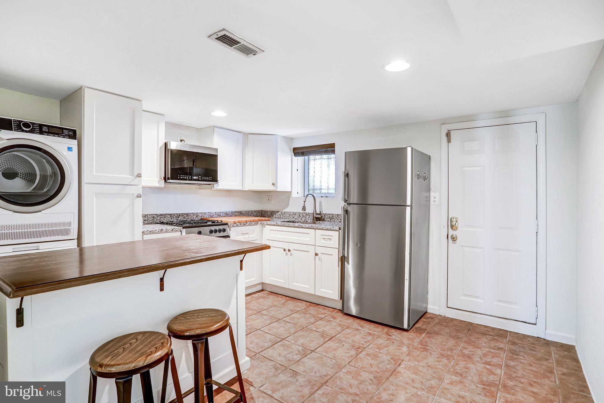 12 Rhode Island Avenue Northwest Washington, DC 20001 - Photo 66 of 74 a kitchen with a refrigerator a stove top oven a sink and dishwasher