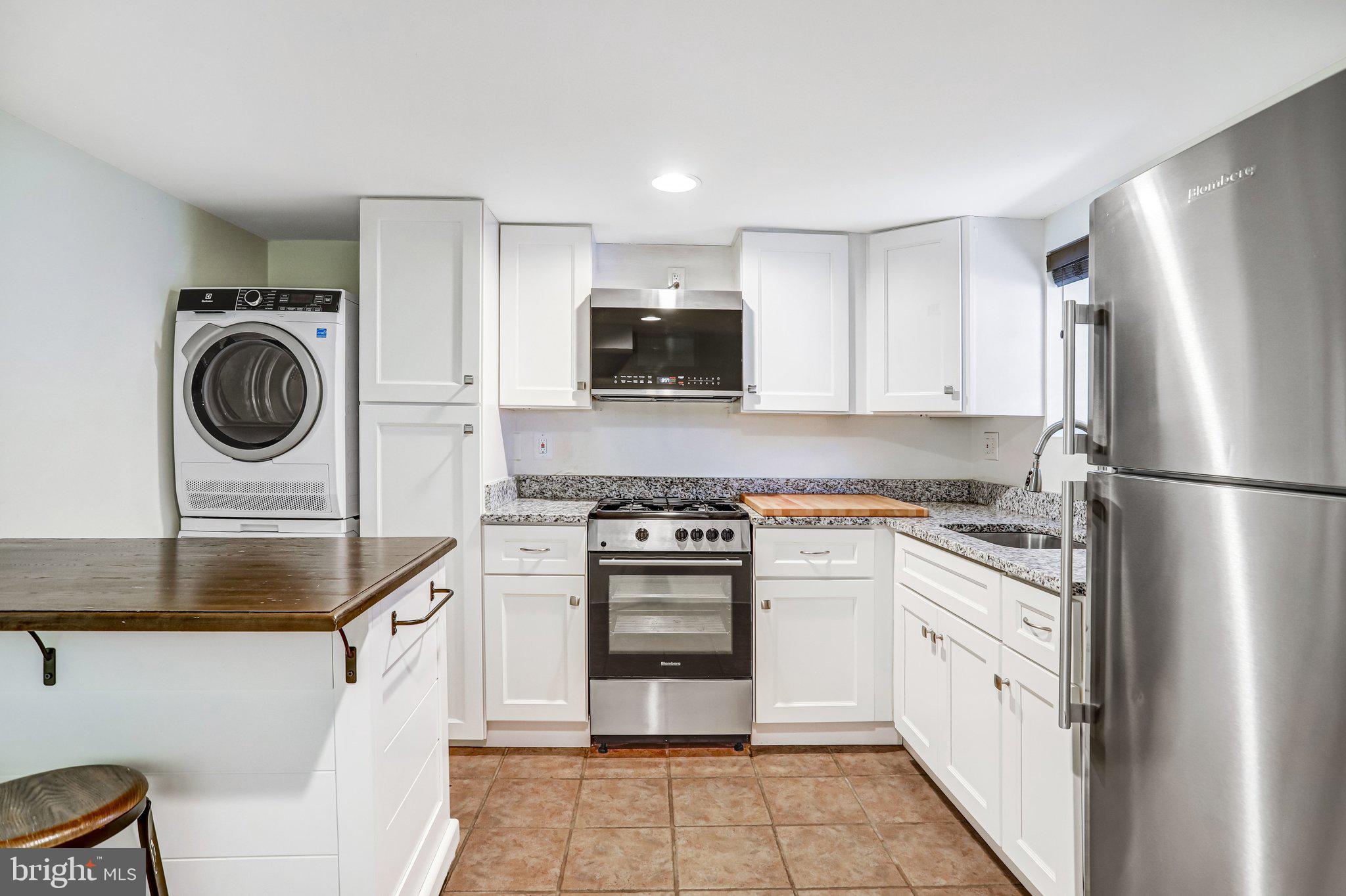 12 Rhode Island Avenue Northwest Washington, DC 20001 - Photo 68 of 74 a kitchen with cabinets a washer and dryer
