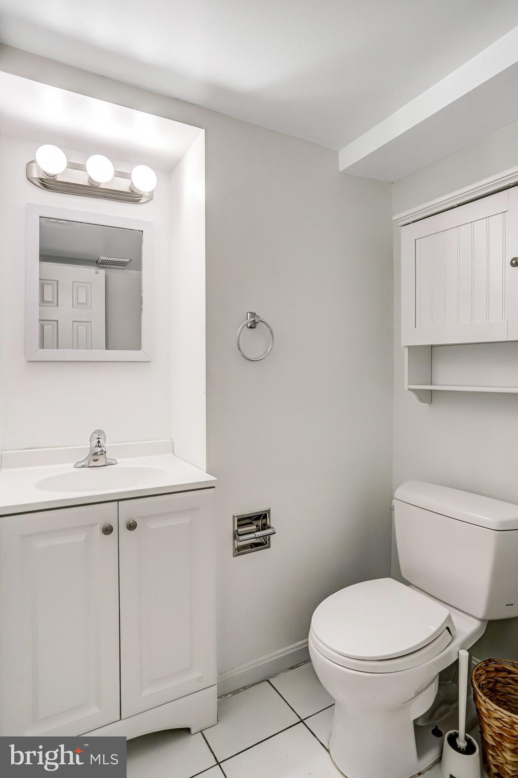12 Rhode Island Avenue Northwest Washington, DC 20001 - Photo 70 of 74 a bathroom with a toilet a sink a mirror and vanity