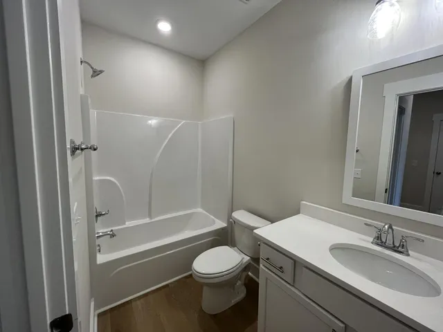 a view of hallway with stairs and wooden floor