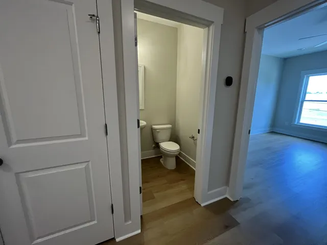 a kitchen with stainless steel appliances granite countertop a sink a stove and a wooden floors