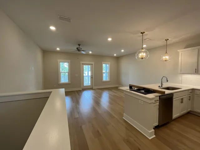 a kitchen that has a lot of stainless steel appliances a refrigerator and a stove top oven