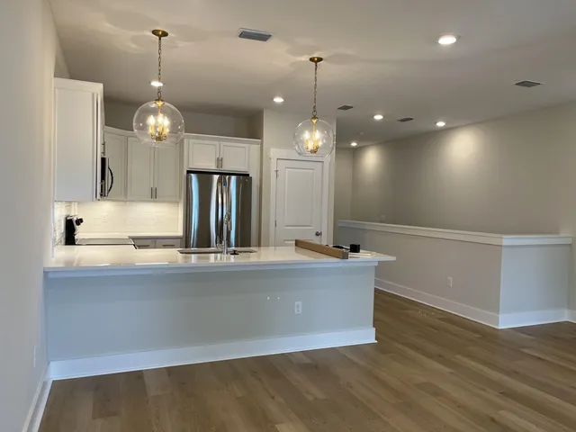 a kitchen with kitchen island granite countertop a sink and stove