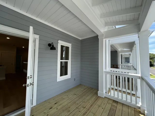 a view of backyard with deck and wooden floor