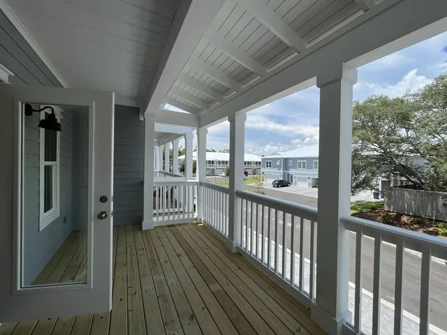 a view of a kitchen with a sink and wooden floor