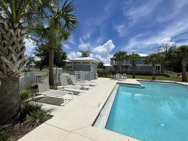 a bathroom with a toilet a sink a mirror and a shower