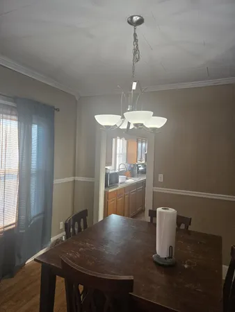 a kitchen with a table and chair