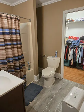a bathroom with a toilet and a shower