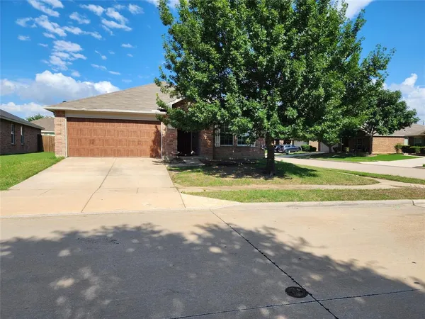 a view of a house with a yard and tree s