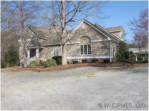2301 North River Road Tryon, NC 28782 - Photo 1 of 12 a front view of a house with a yard and garage