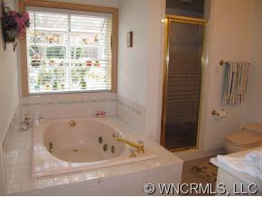 2301 North River Road Tryon, NC 28782 - Photo 7 of 12 a white bath tub sitting next to a toilet