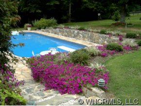 2301 North River Road Tryon, NC 28782 - Photo 10 of 12 a view of a garden with flowers and trees