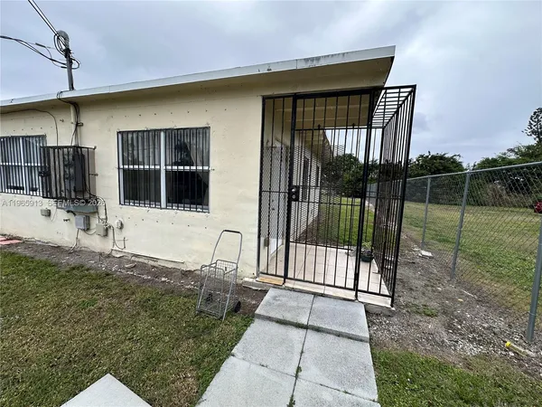 a view of a house with a backyard and porch