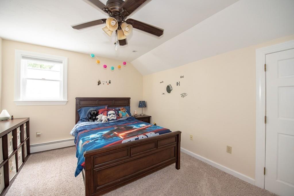 195 Kaleva Road Lancaster, MA 01523 - Photo 27 of 39 a bedroom with a bed and a chandelier fan